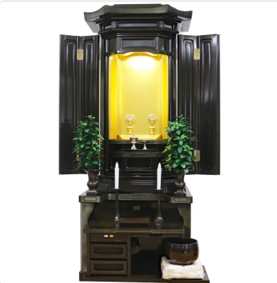 A dark wooden Buddhist home altar (butsudan) with open doors revealing a golden inner shrine and two flower arrangements.